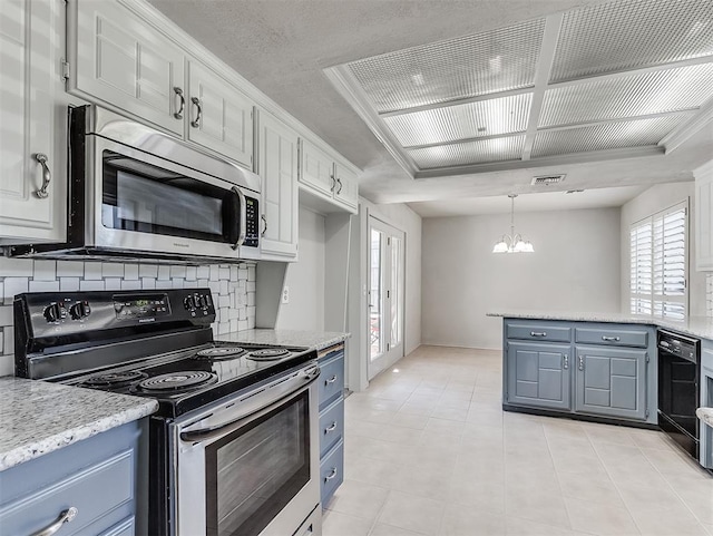 kitchen with white cabinets, stainless steel appliances, and decorative light fixtures