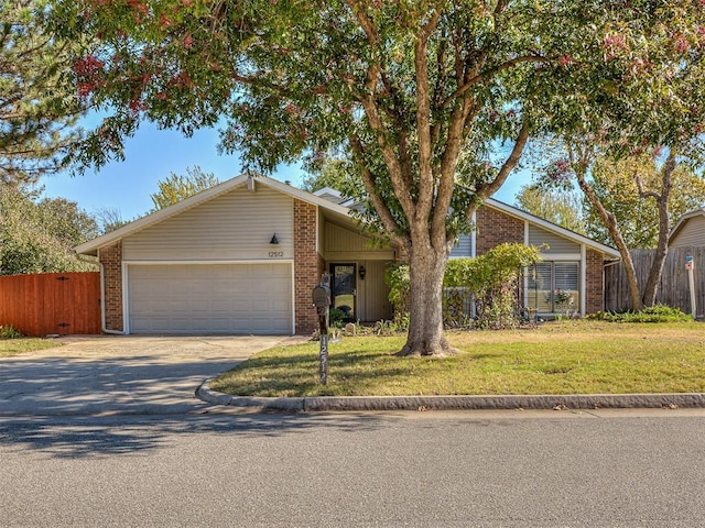 ranch-style home featuring a front lawn and a garage