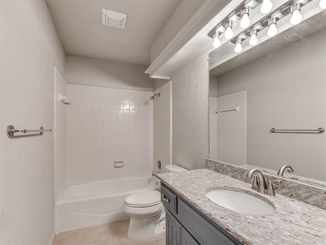 full bathroom featuring tile patterned flooring, vanity, tiled shower / bath combo, and toilet