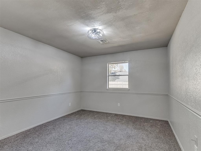 empty room featuring carpet floors and a textured ceiling