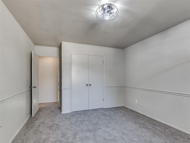 unfurnished bedroom with light carpet and a closet