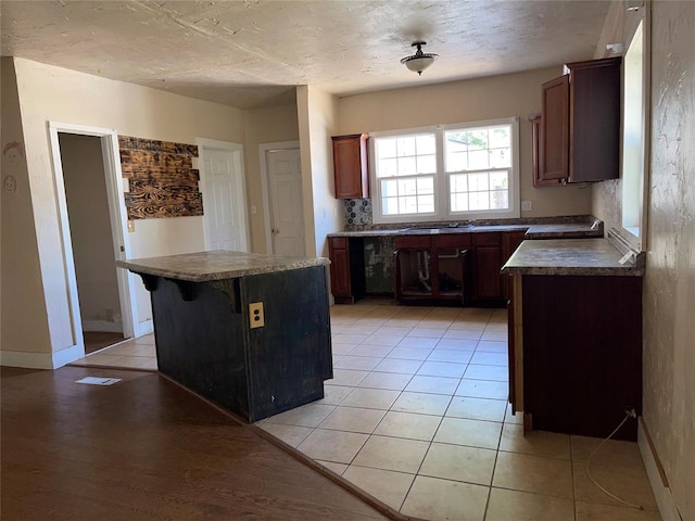 kitchen with a breakfast bar, a center island, and light hardwood / wood-style floors