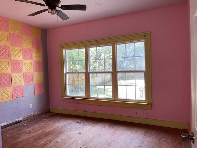 spare room featuring hardwood / wood-style flooring and ceiling fan