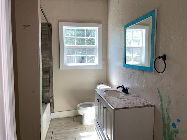 full bathroom with vanity, a healthy amount of sunlight, toilet, and shower / bathtub combination