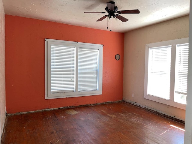 empty room with hardwood / wood-style flooring and ceiling fan