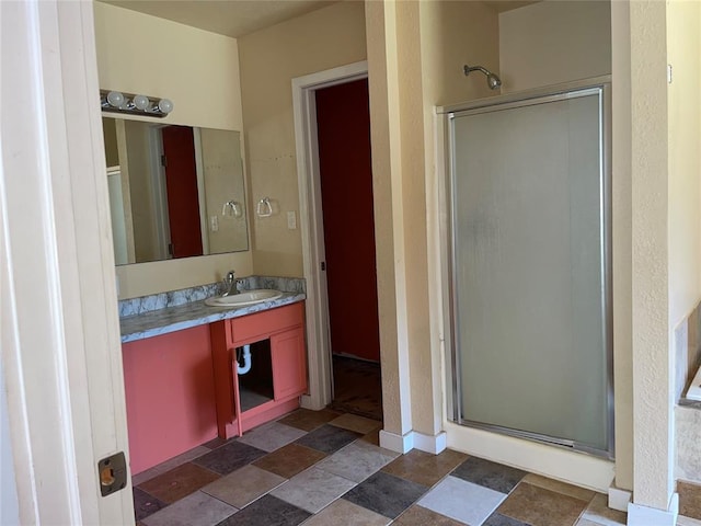 bathroom featuring vanity and a shower with door