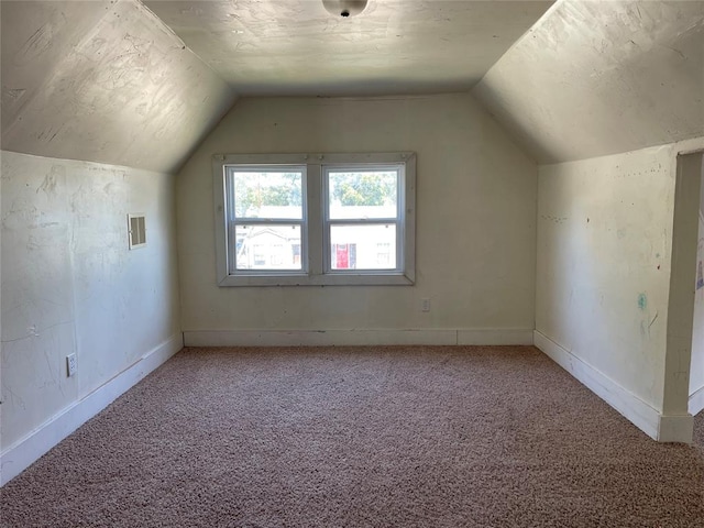 bonus room featuring carpet flooring and vaulted ceiling