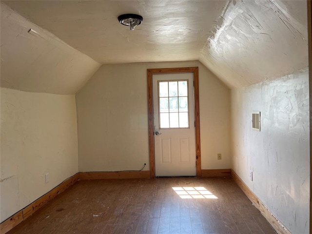 bonus room featuring dark hardwood / wood-style flooring and lofted ceiling