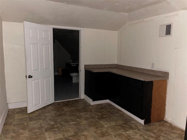 unfurnished room with lofted ceiling