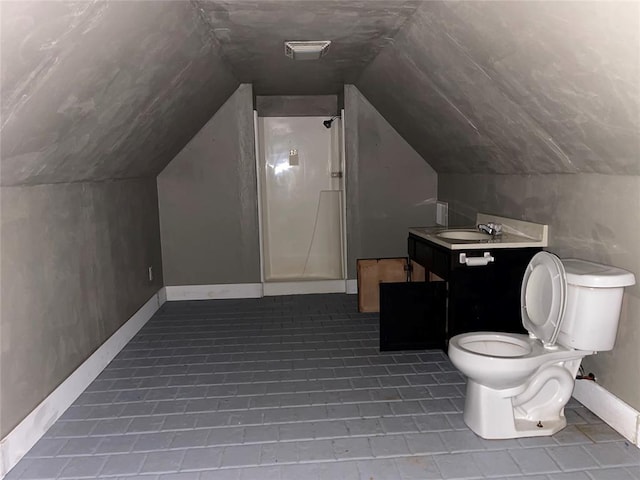 bathroom with toilet, a shower, vanity, and vaulted ceiling