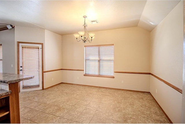 unfurnished dining area featuring vaulted ceiling and an inviting chandelier