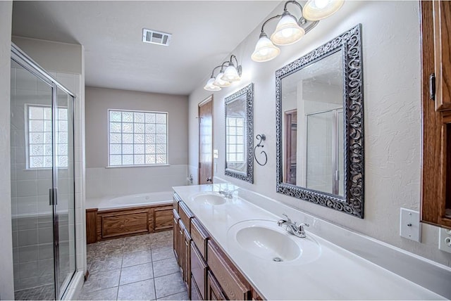 bathroom with tile patterned flooring, shower with separate bathtub, and vanity