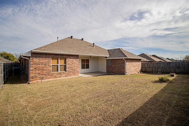 rear view of house featuring a lawn, a patio area, and central air condition unit