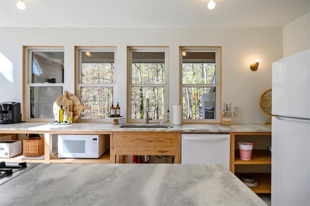 kitchen featuring white appliances and sink