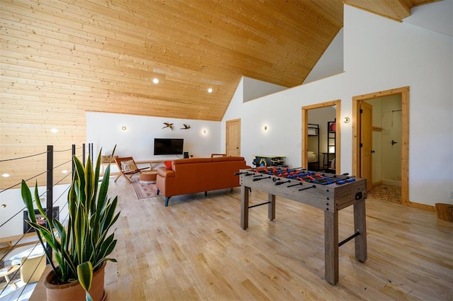 recreation room with light wood-type flooring, high vaulted ceiling, and wood ceiling