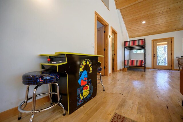 rec room featuring wood ceiling, vaulted ceiling, and light wood-type flooring