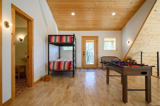 recreation room with lofted ceiling, light hardwood / wood-style floors, and wooden ceiling