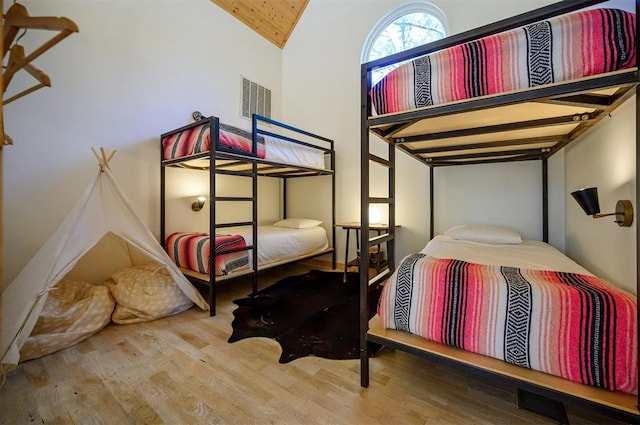 bedroom with hardwood / wood-style flooring and vaulted ceiling