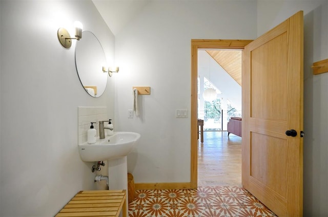 bathroom with sink and vaulted ceiling