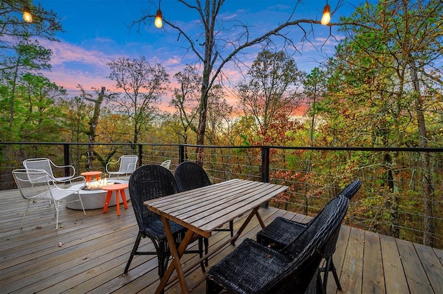 deck at dusk with a fire pit