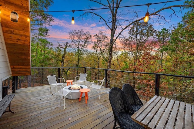 deck at dusk with an outdoor fire pit