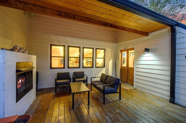 deck featuring an outdoor living space with a fireplace