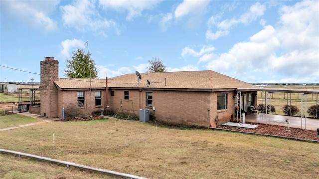 back of house featuring a yard and cooling unit