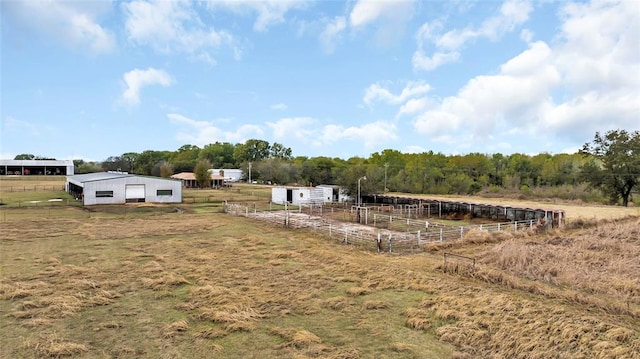 view of yard with a rural view and an outdoor structure