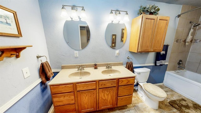 full bathroom featuring vanity, tiled shower / bath combo, and toilet