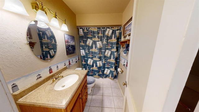 bathroom with a shower with curtain, tile patterned flooring, vanity, and toilet