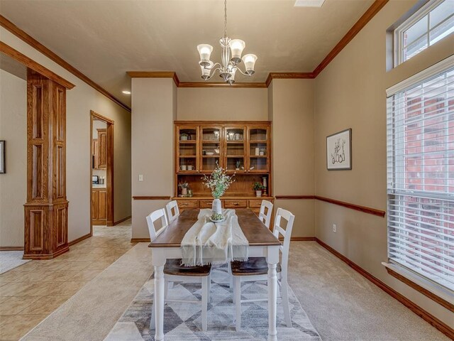 dining area with an inviting chandelier, crown molding, and light carpet