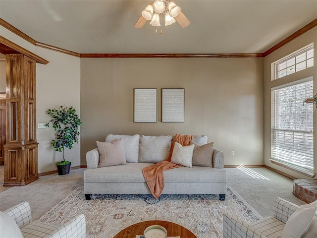 living room with crown molding, ceiling fan, and carpet flooring