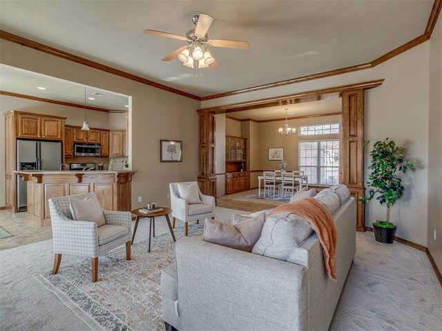 living room featuring ornamental molding, light carpet, and ceiling fan with notable chandelier