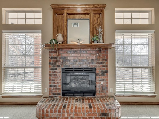 interior details with a brick fireplace and carpet