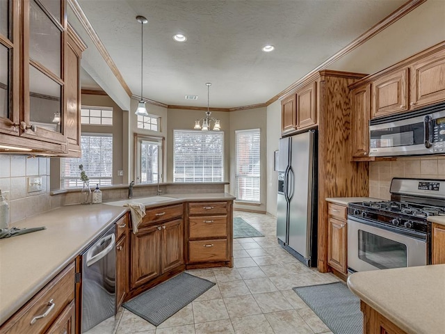 kitchen with decorative light fixtures, tasteful backsplash, ornamental molding, light tile patterned floors, and stainless steel appliances