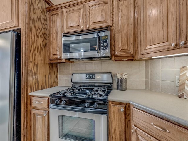 kitchen featuring stainless steel appliances and decorative backsplash