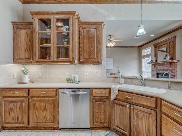 kitchen with decorative light fixtures, sink, backsplash, stainless steel dishwasher, and crown molding