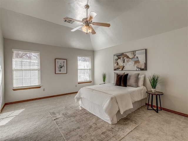 carpeted bedroom with ceiling fan and lofted ceiling