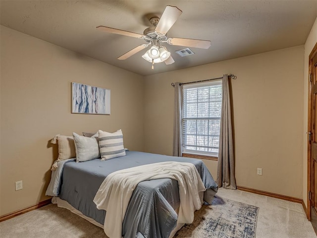 bedroom featuring ceiling fan and light carpet