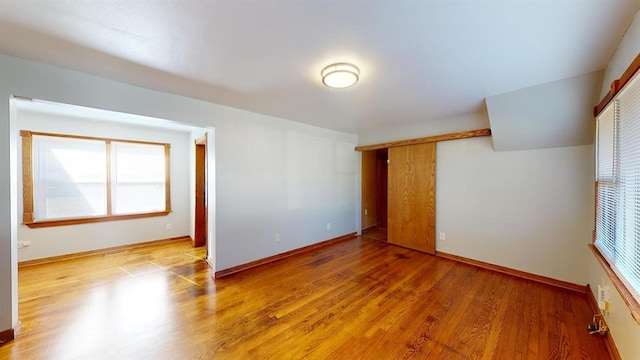 empty room with light hardwood / wood-style flooring