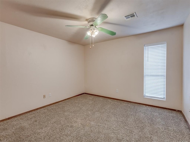 carpeted spare room with ceiling fan