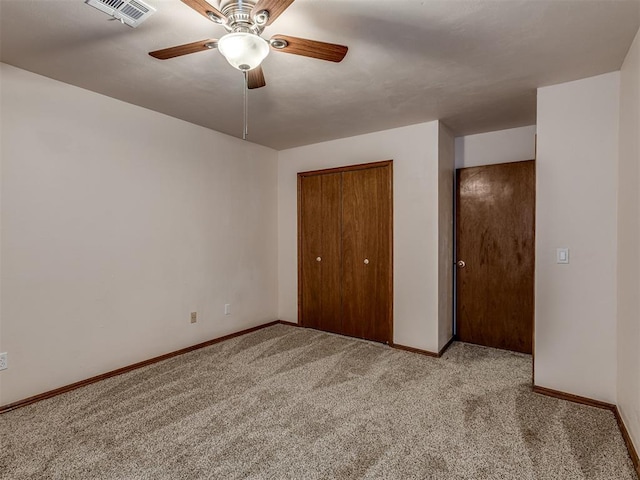 unfurnished bedroom with light colored carpet, ceiling fan, and a closet