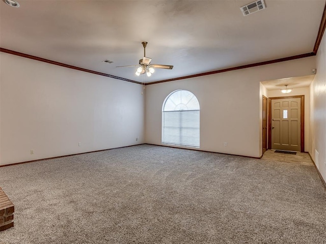 carpeted empty room with crown molding and ceiling fan