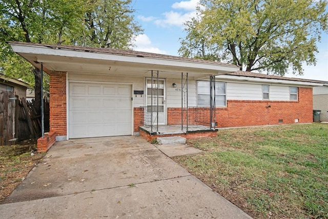 ranch-style home with a front yard and a garage