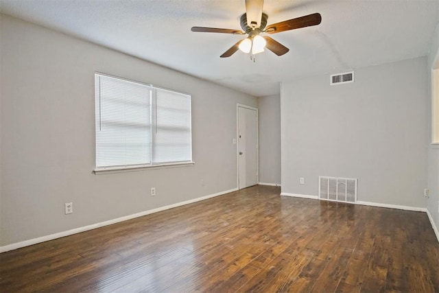 unfurnished room with ceiling fan and dark hardwood / wood-style flooring