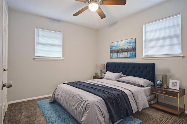 carpeted bedroom with multiple windows and ceiling fan