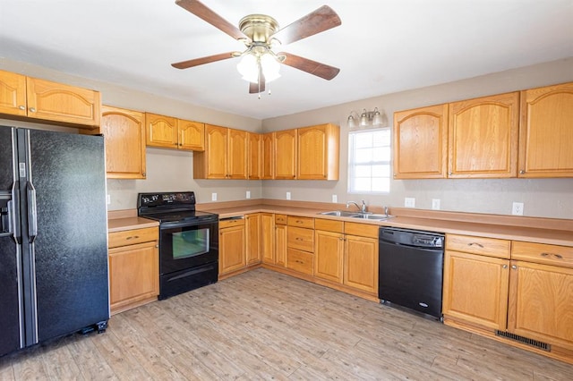 kitchen featuring sink, light wood-type flooring, ceiling fan, and black appliances