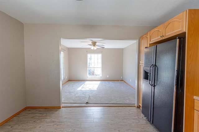 kitchen featuring black fridge with ice dispenser, light brown cabinets, light hardwood / wood-style floors, and ceiling fan