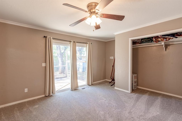 unfurnished bedroom featuring ceiling fan, crown molding, and light carpet