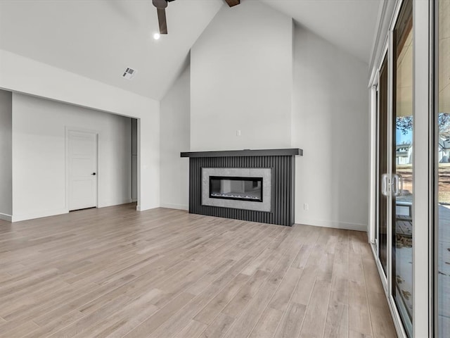 unfurnished living room with beamed ceiling, high vaulted ceiling, light hardwood / wood-style flooring, and ceiling fan